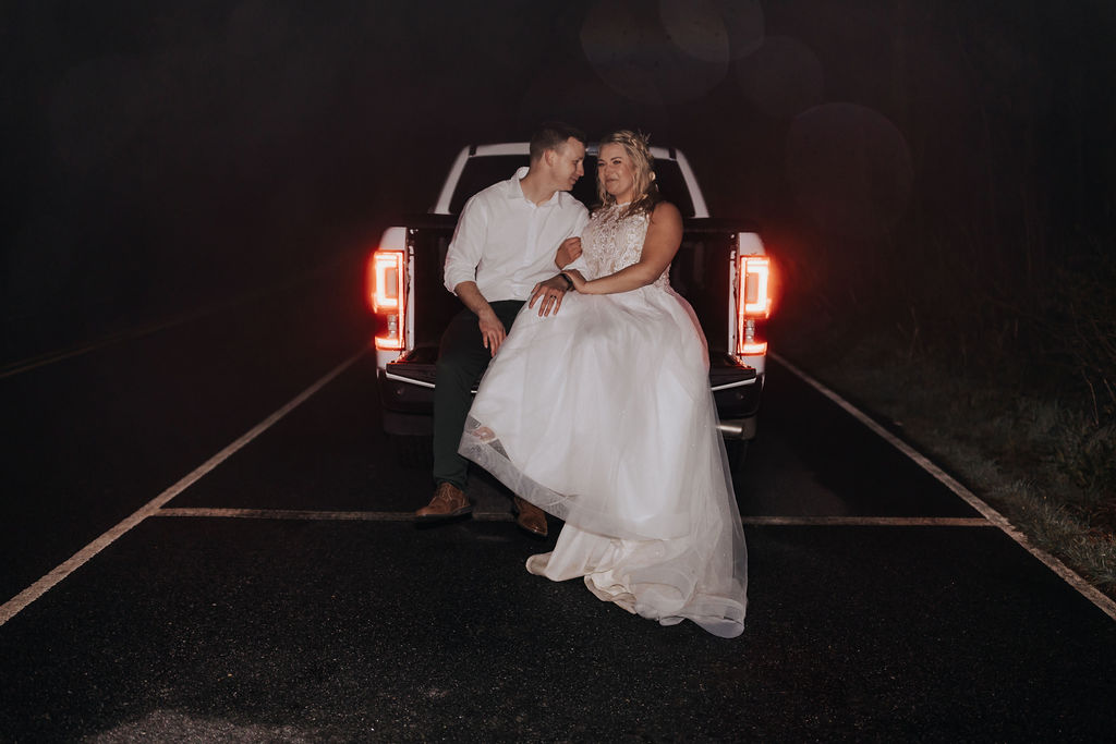 Nashville elopement photographer captures couple sitting on truck bed in wedding attire