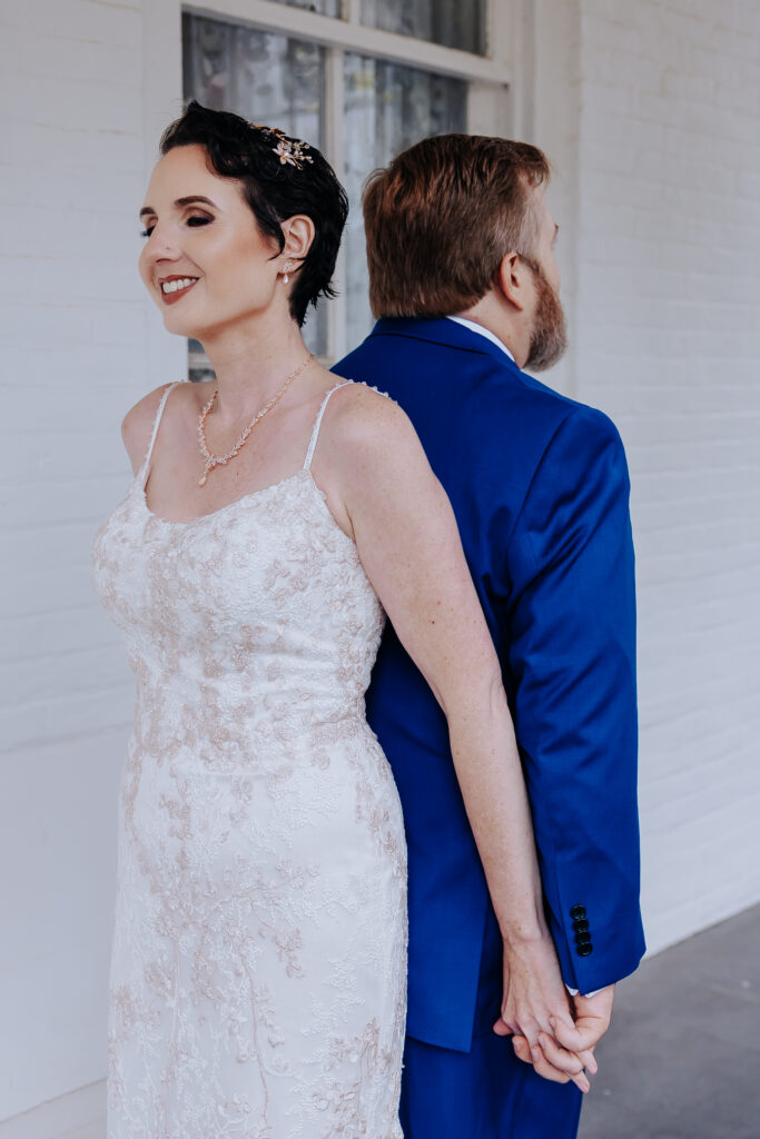 Nashville elopement photographer captures bride and groom holding hands before first look