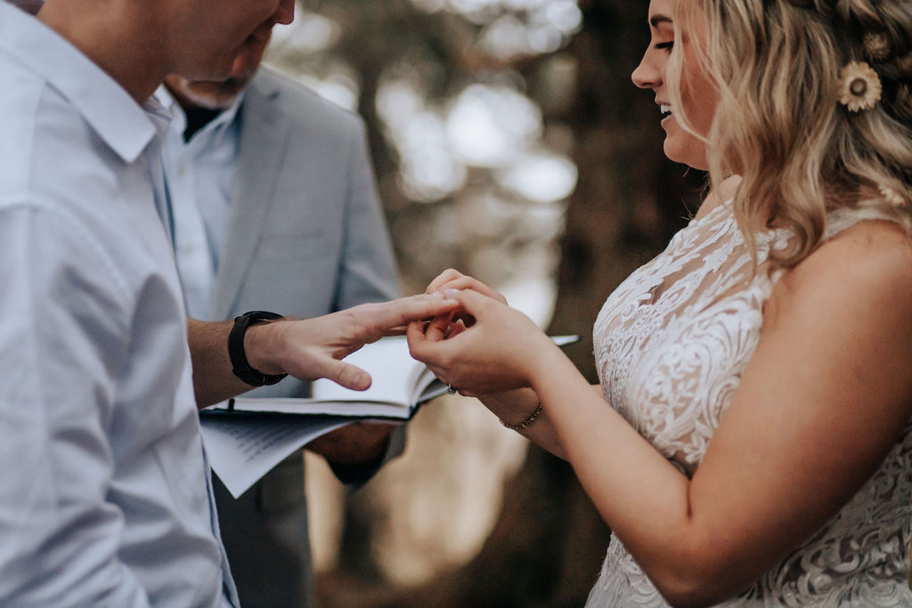 Nashville elopement photographer captures bride placing ring on groom's finger