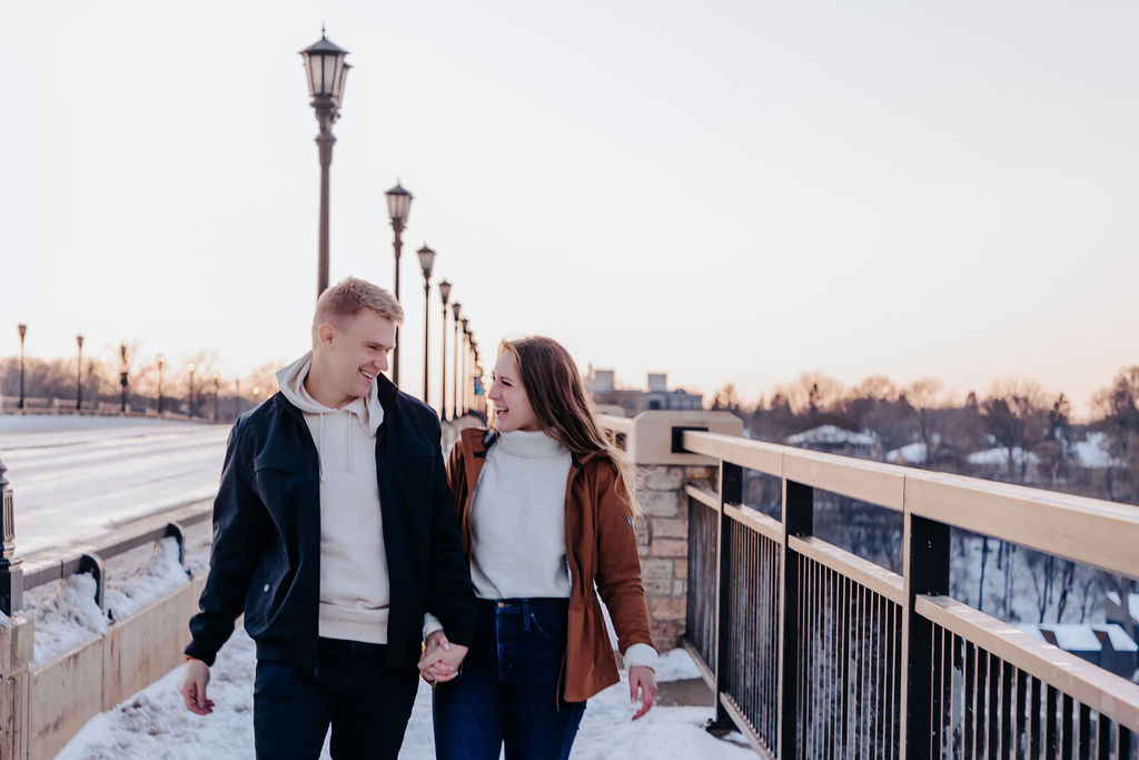 Nashville elopement photographer captures couple walking hand in hand on dock during winter engagements