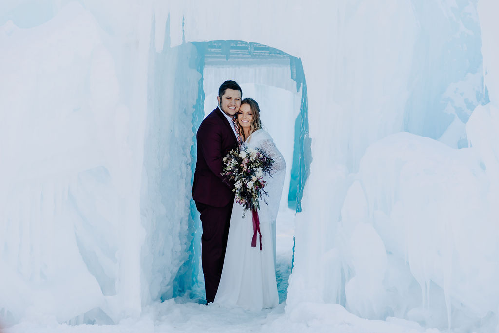 Destination Elopement Photographers capture bride and groom in ice castle in Idaho