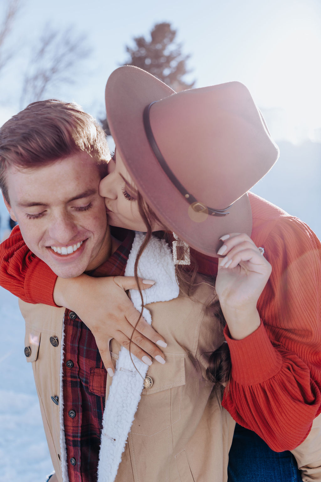 Nashville elopement photographer captures woman on man's back wearing hat