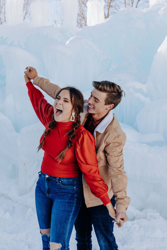 Nashville elopement photographe captures couple holding hands and spinning together after choosing winter engagement outfits
