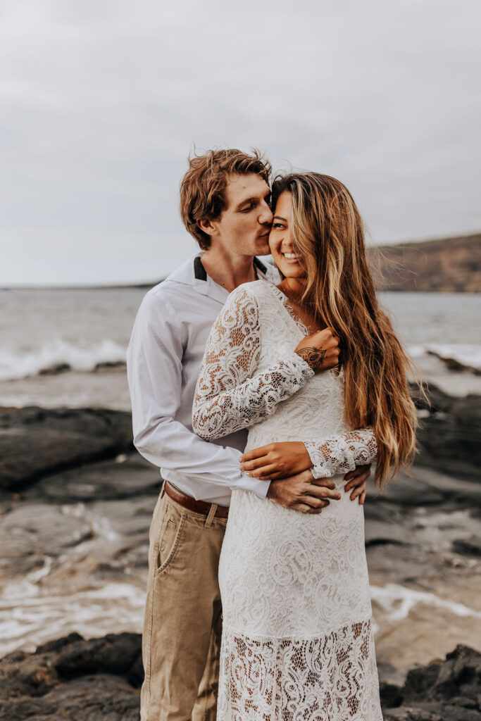 Big Island elopement phtoographer captures grooom hugging bride from behind