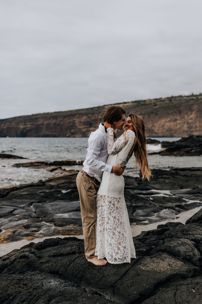 Big Island elopement photographer captures newly married couple kissing on beach