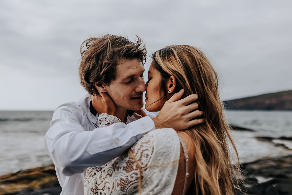 Big Island elopement photographer captures close up of bride and groom embracing one another and looking at one another's eyes