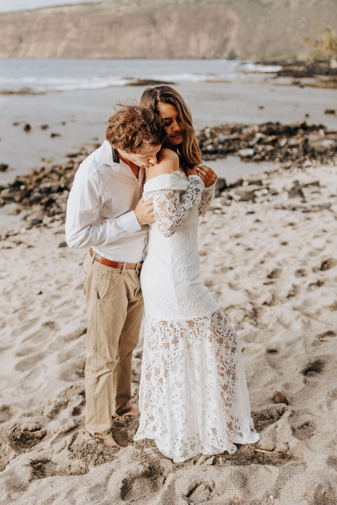 Big Island elopement photographer captures man hugging woman from behind after Big Island elopement