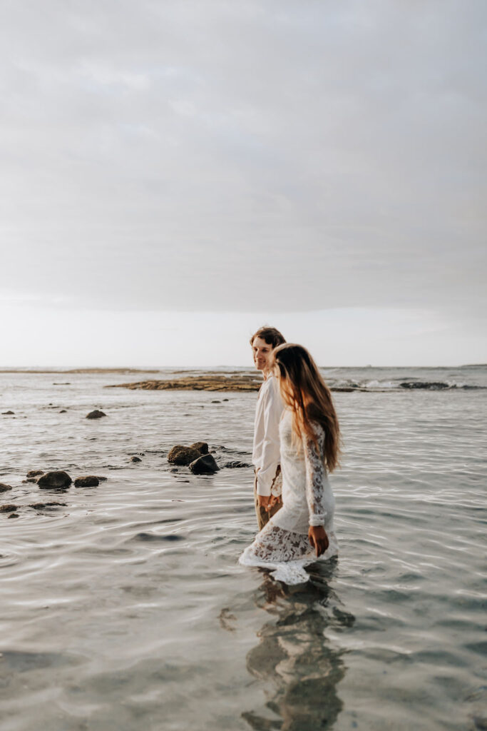Big Island elopement photographer captures couple walking into water as husband and wife