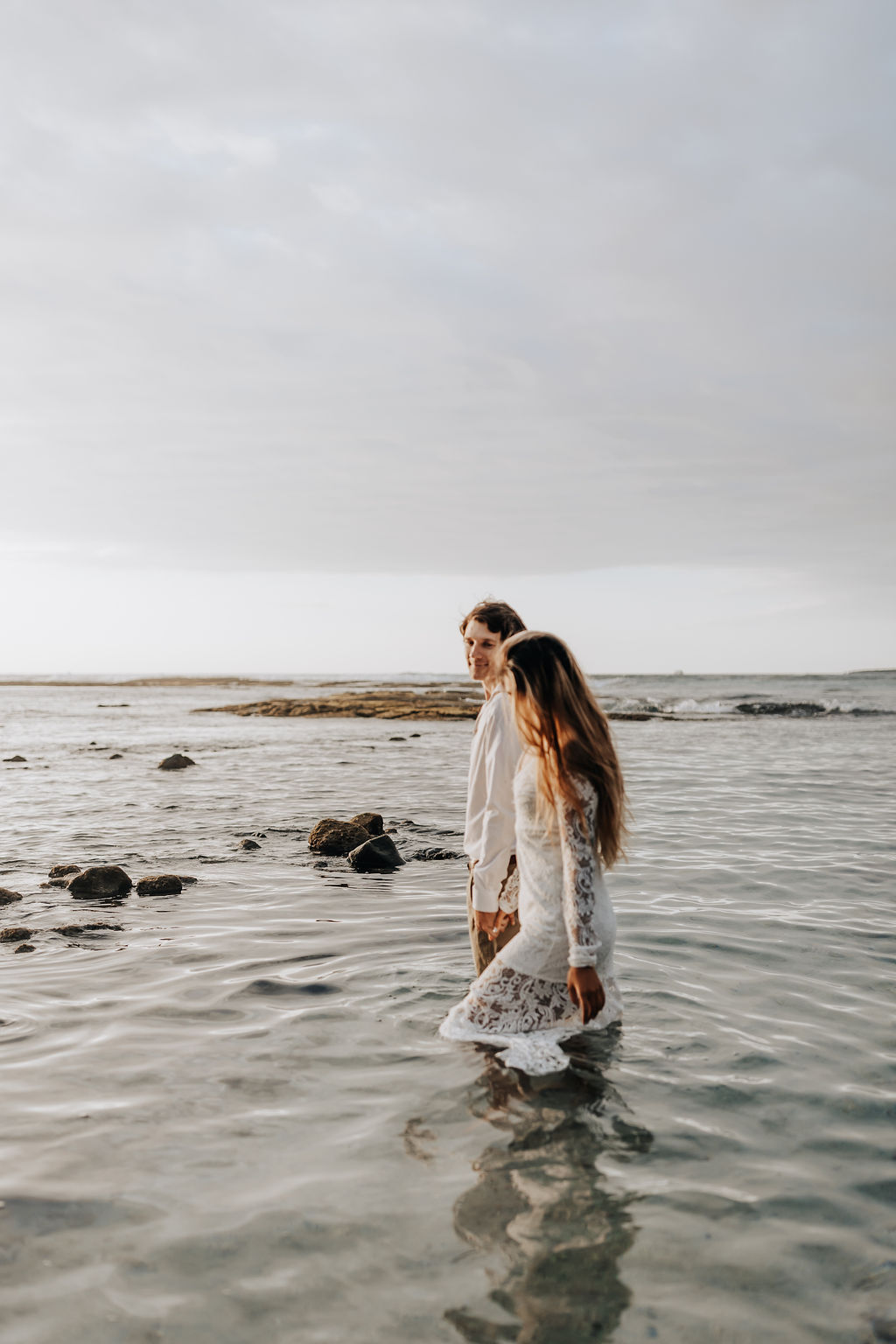 Big Island elopement photographer captures couple walking into water as husband and wife