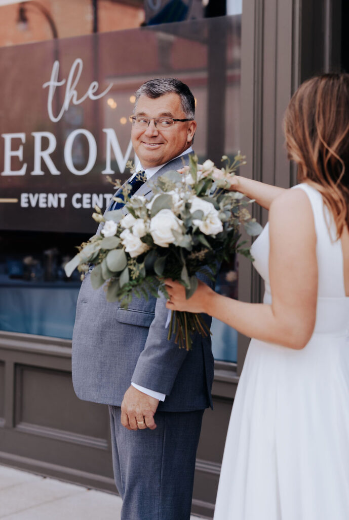 Nashville elopement photographer captures bride tapping father on shoulder before first look