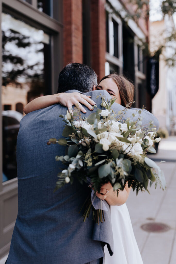 Nashville elopement photographer captures bride hugging father after first look