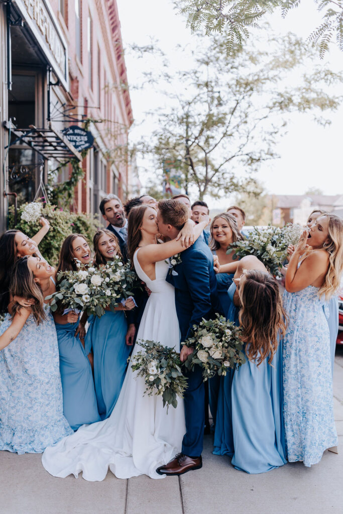 Nashville elopement photographer captures bride and groom kissing while wedding party cheers