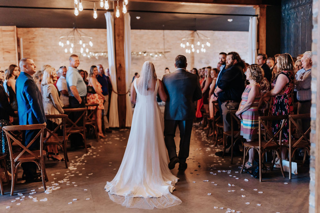 Minneapolis wedding photographer captures bride and father walking down aisle