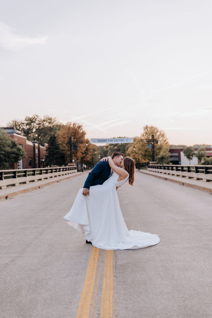 Minneapolis wedding photographer captures couple kissing in street