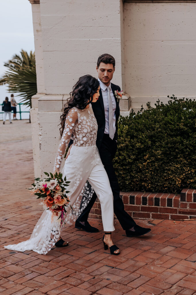 Nashville elopement photographer captures bride and groom walking with bride wearing pantsuit