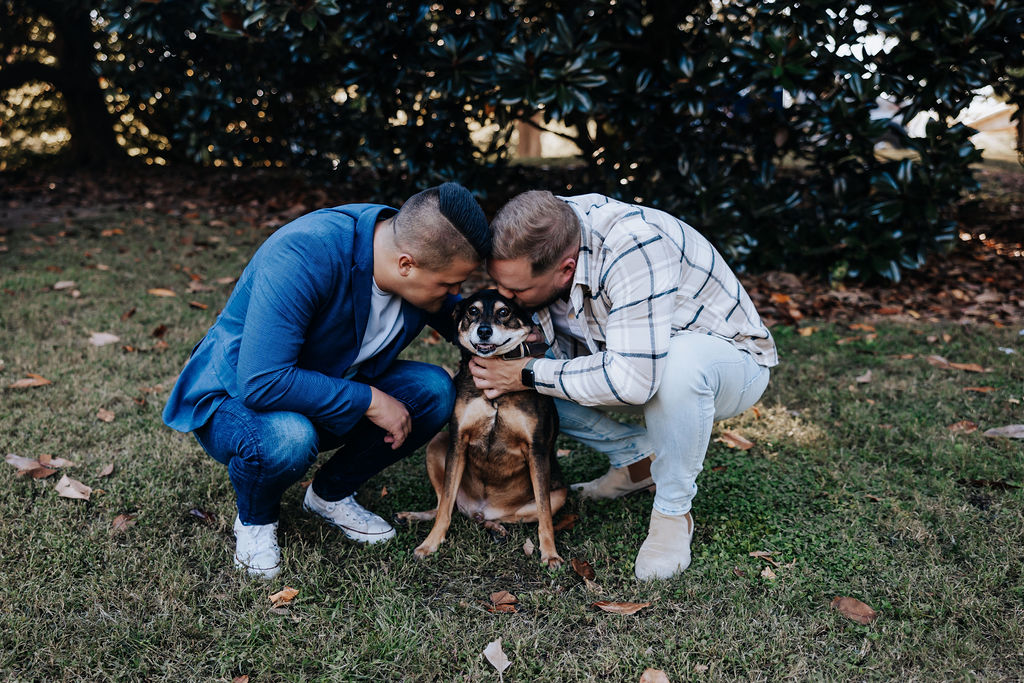 Nashville engagement photographer captures engaged couple hugging dog during Centennial Park engagement photos