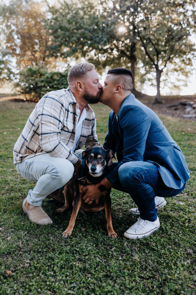 Nashville engagement photographer captures couple kissing while petting dog
