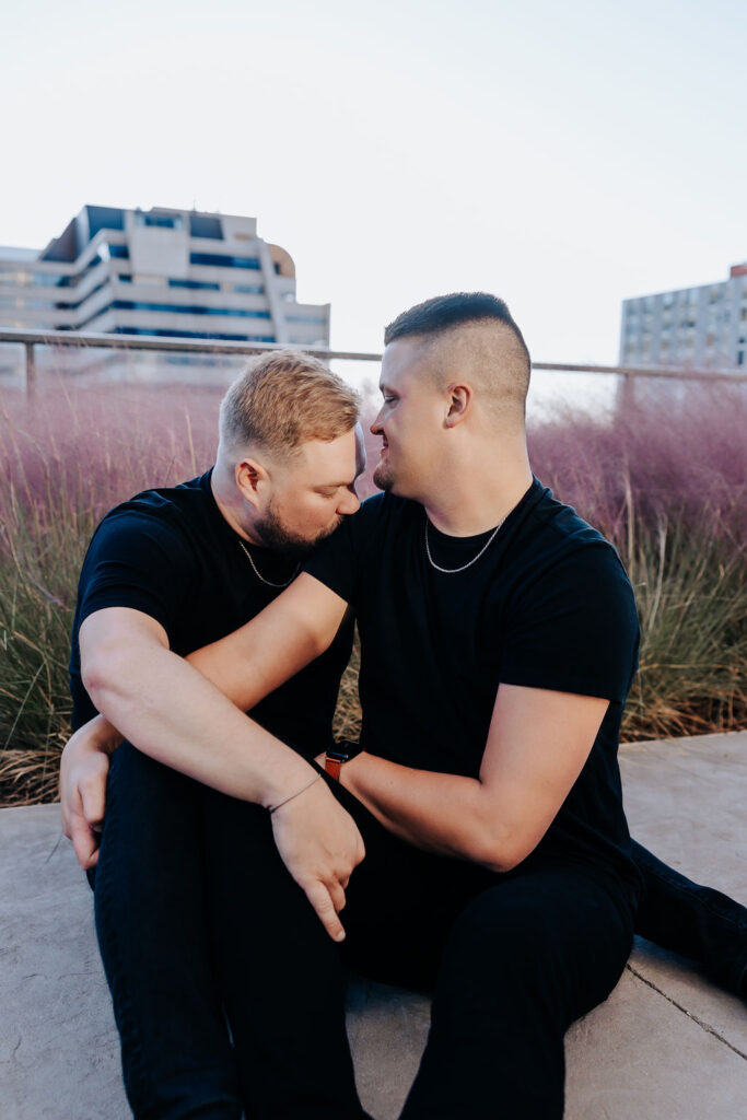 Nashville engagement photographer captures men wearing black shirts cuddling