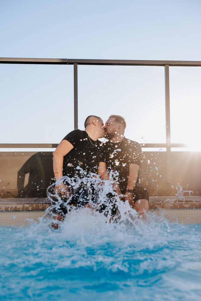 Nashville engagement photographer captures couple kissing while splashing in pool