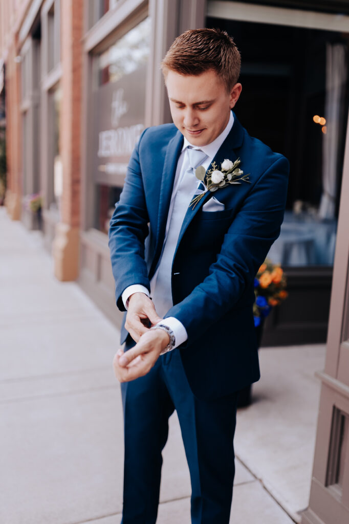 Nashville elopement photographer captures groom adjusting sleeves on suit before wedding
