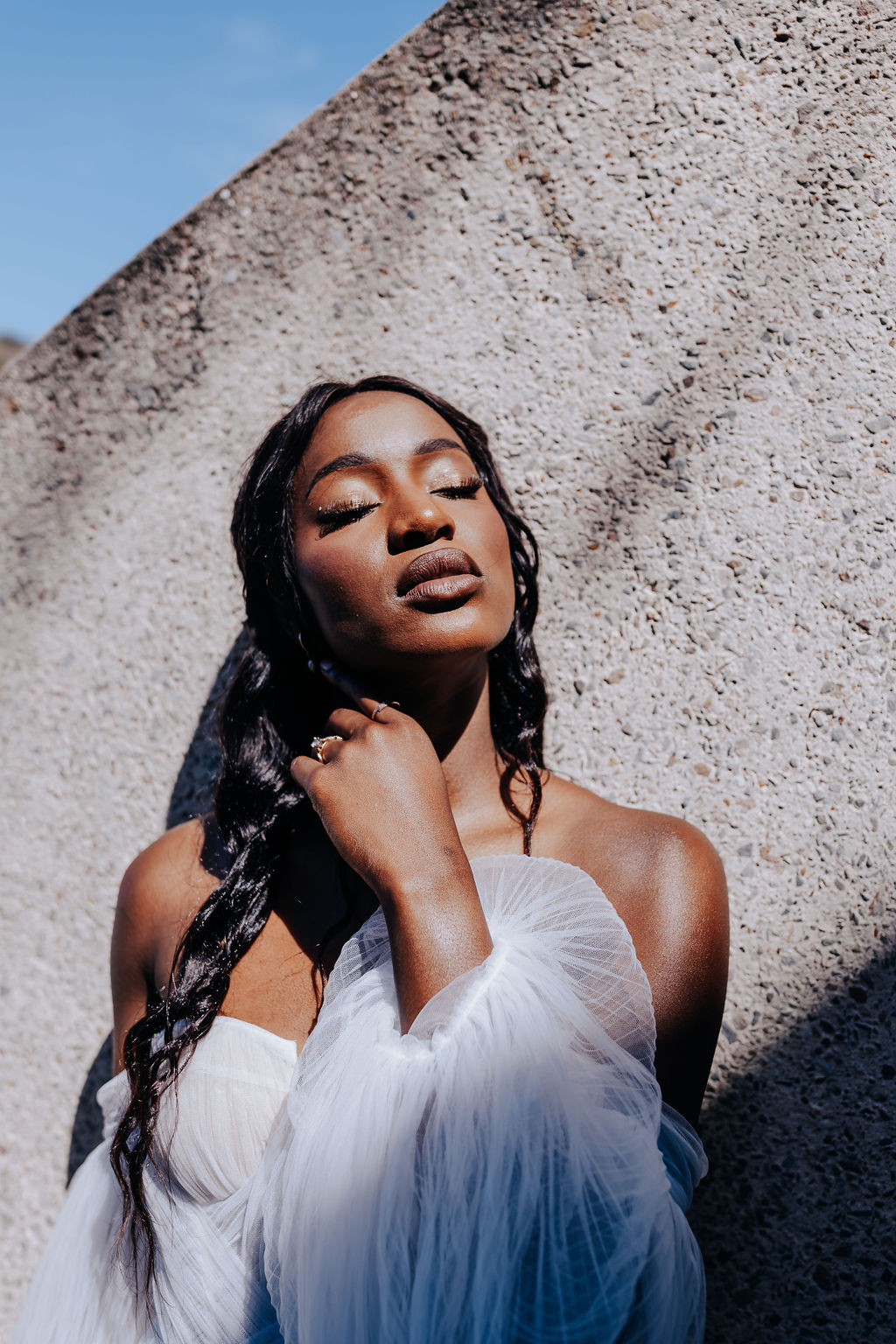 Destination elopement photographer captures bride closing eyes and sun shining