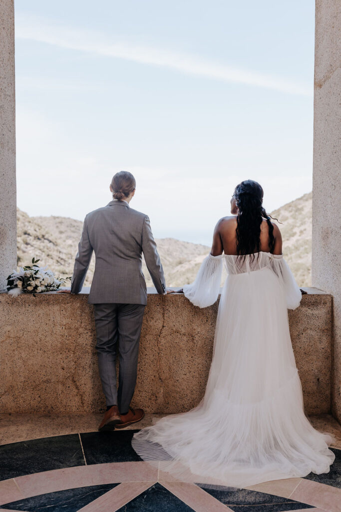 Destination Wedding Photographer captures bride and groom looking out on view during destination elopement