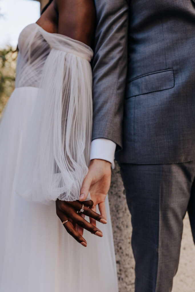 Destination elopement photographer captures couple holding hands in wedding attire after romantic Catalina Island elopement