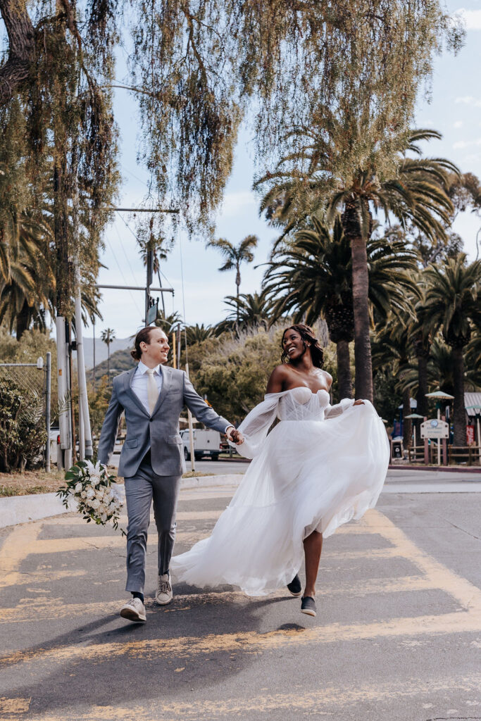 Destination Wedding Photographer captures bride and groom crossing street after destination wedding