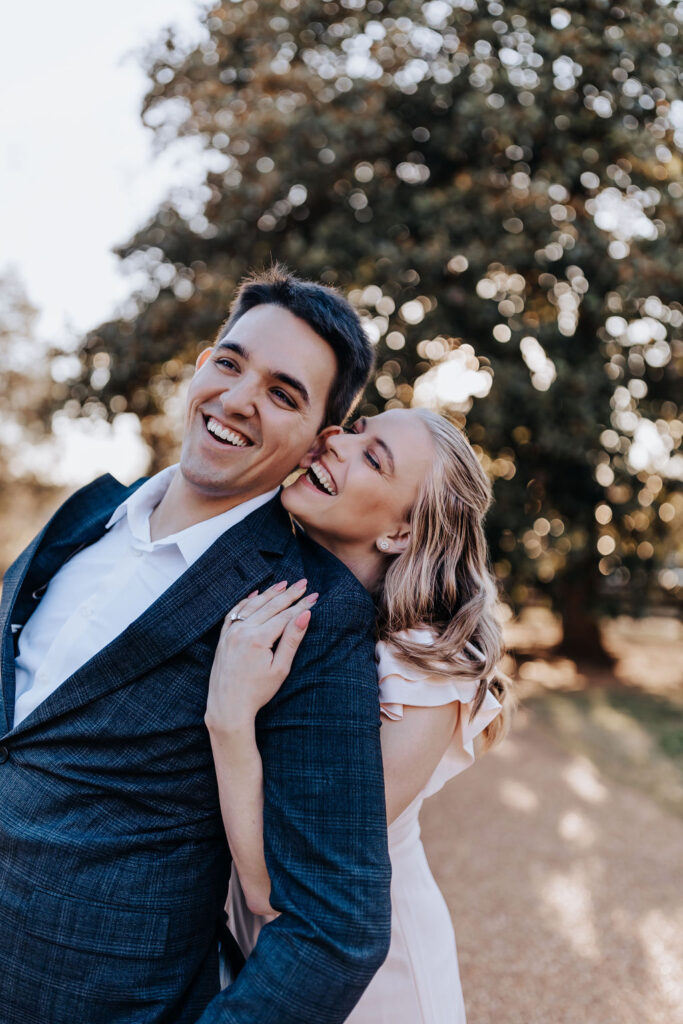 Nashville elopement photographer captures woman hugging man from behind during engagement photos