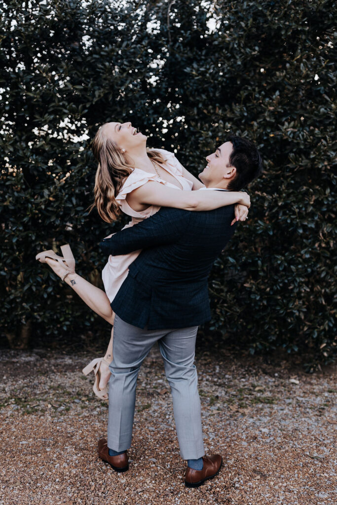 Nashville elopement photographer captures man lifting woman during charming tennessee winery engagement