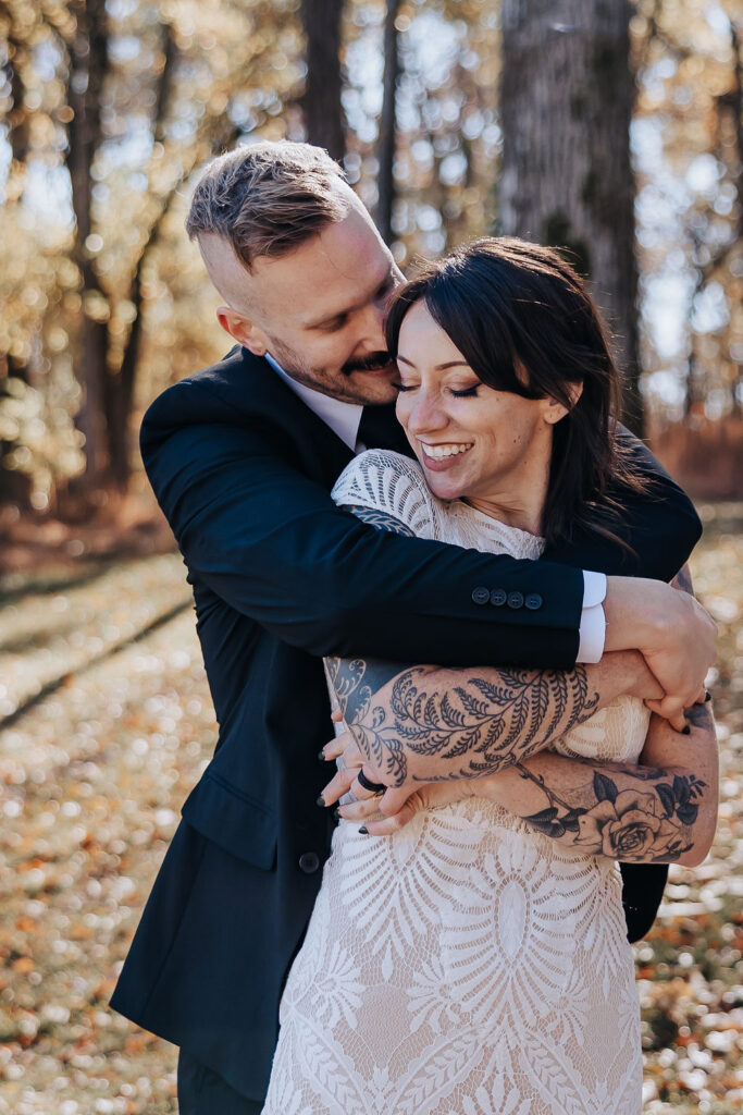 Nashville elopement photographer captures man hugging woman from behind after wedding