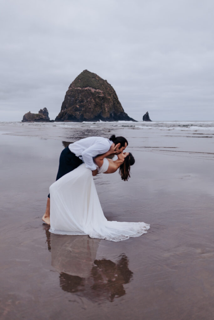 Destination wedding photographer captures bride and groom kissing on Oregon Coast 