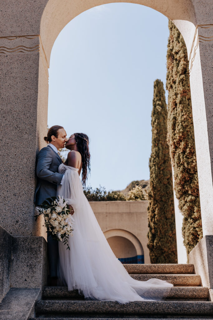 Destination elopement photographer captures bride and groom kissing after Catalina Island elopement