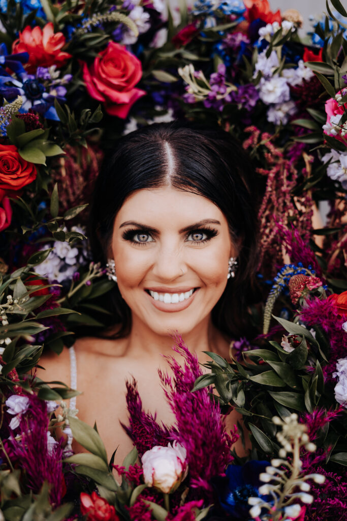 Nashville elopement photographer captures bride surrounded by colored floral bouquets