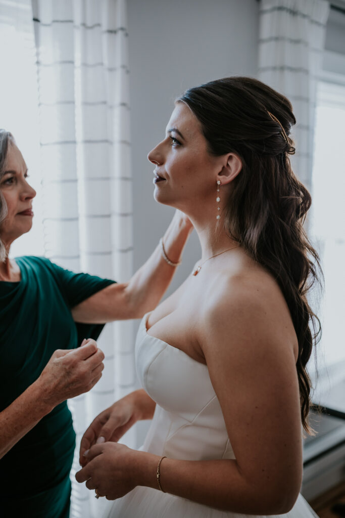 Nashville elopement photographer captures bride getting pearl earrings on
