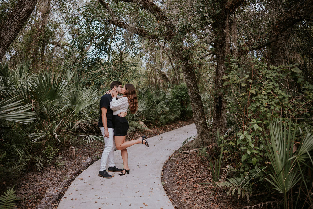 Destination wedding photographer captures couple embracing during spontaneous florida engagement photos