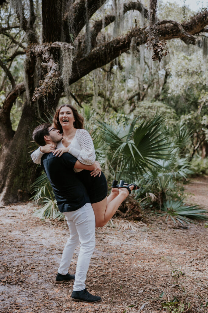 Destination wedding photographer captures man lifting up woman