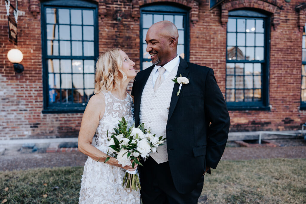Destination elopement photographer captures bride laughing with groom after destination elopement in Downtown Nashville