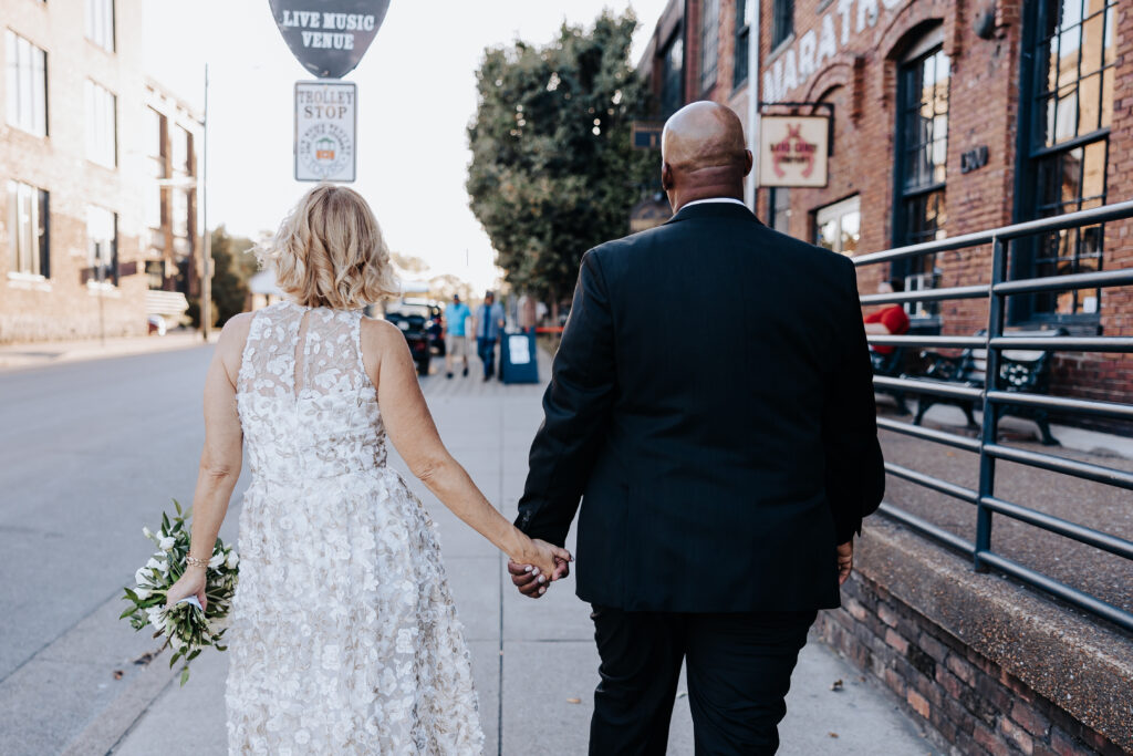Destination elopement photographer captures bride and groom walking down the street after elopement