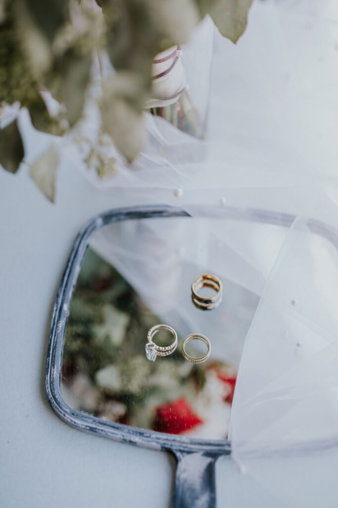 Destination wedding photographer captures mirror with wedding rings on them