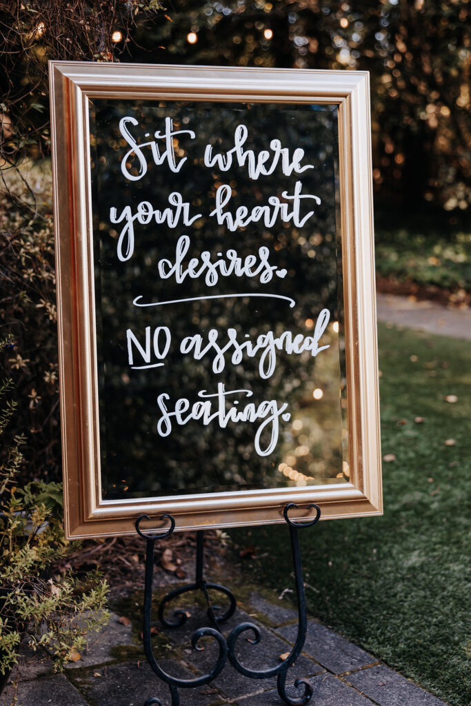 Destination wedding photographer captures mirror with wedding seat sign on it