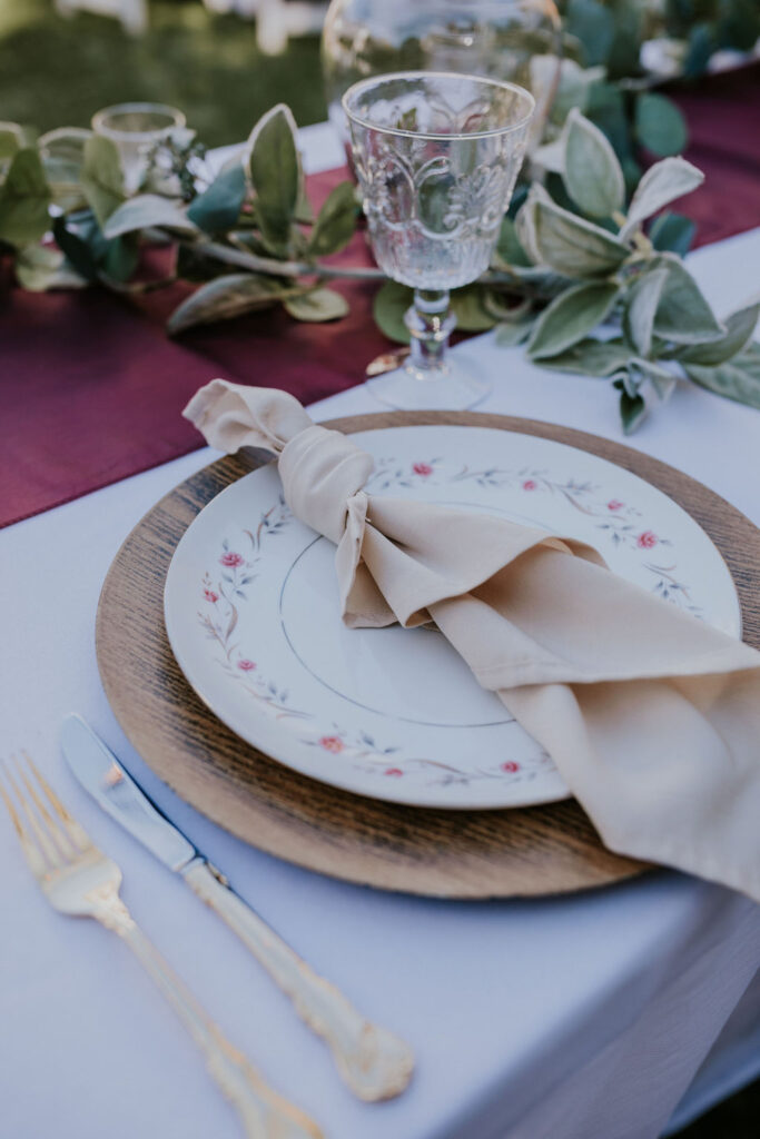 Destination wedding photographer captures close up of plates and napkins at Garden wedding