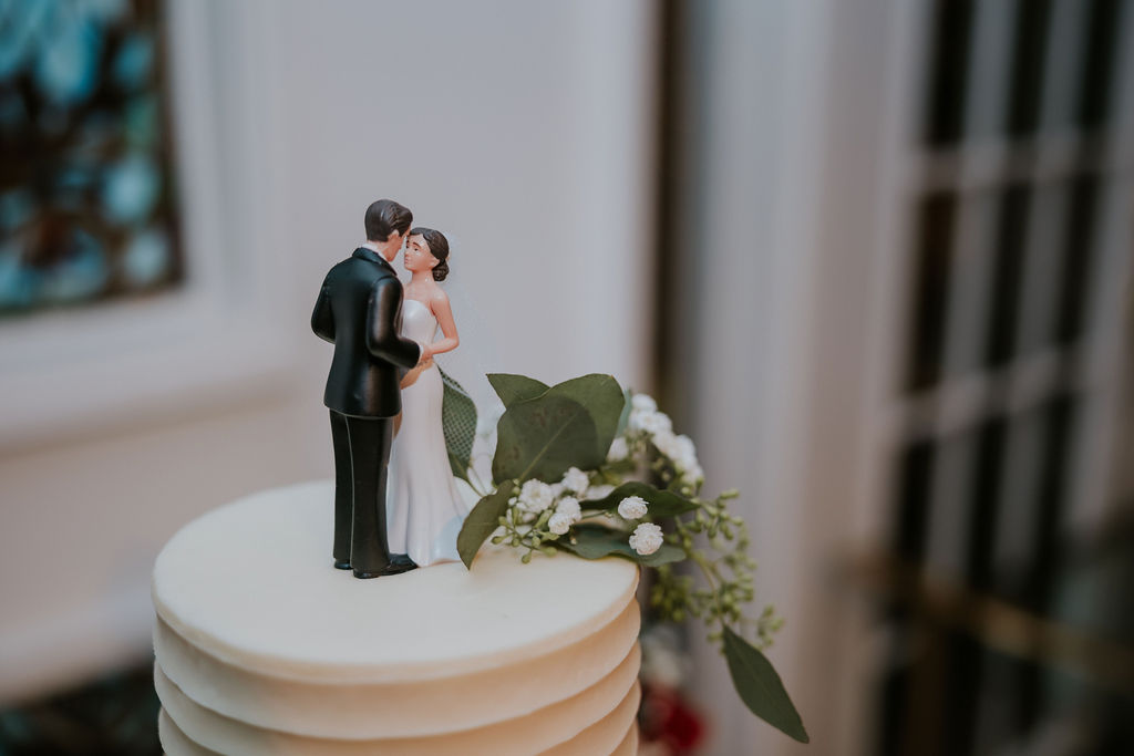 Destination wedding photographer captures close up of bride and groom cake topper