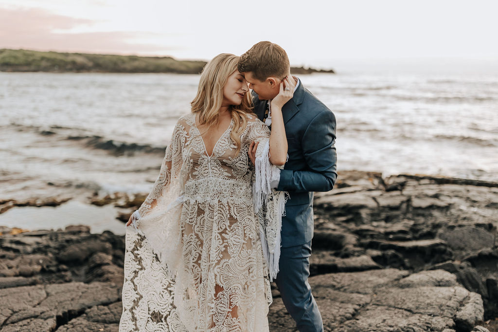 Destination Wedding Photographer captures bride holding groom's neck during beach bridal portraits