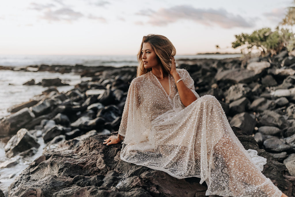 Destination Wedding Photographer captures bride sitting on rocks after destination wedding