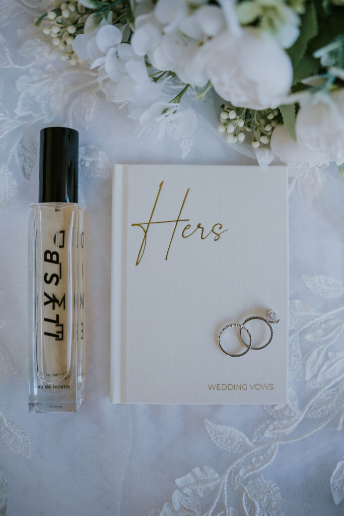 Destination wedding photographer captures bride's details with her perfume and vow book