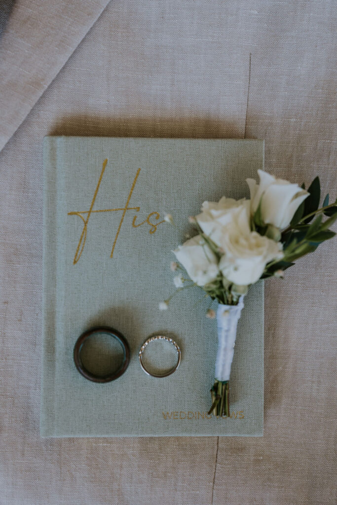 Destination wedding photographer captures groom's vow book during detail shots