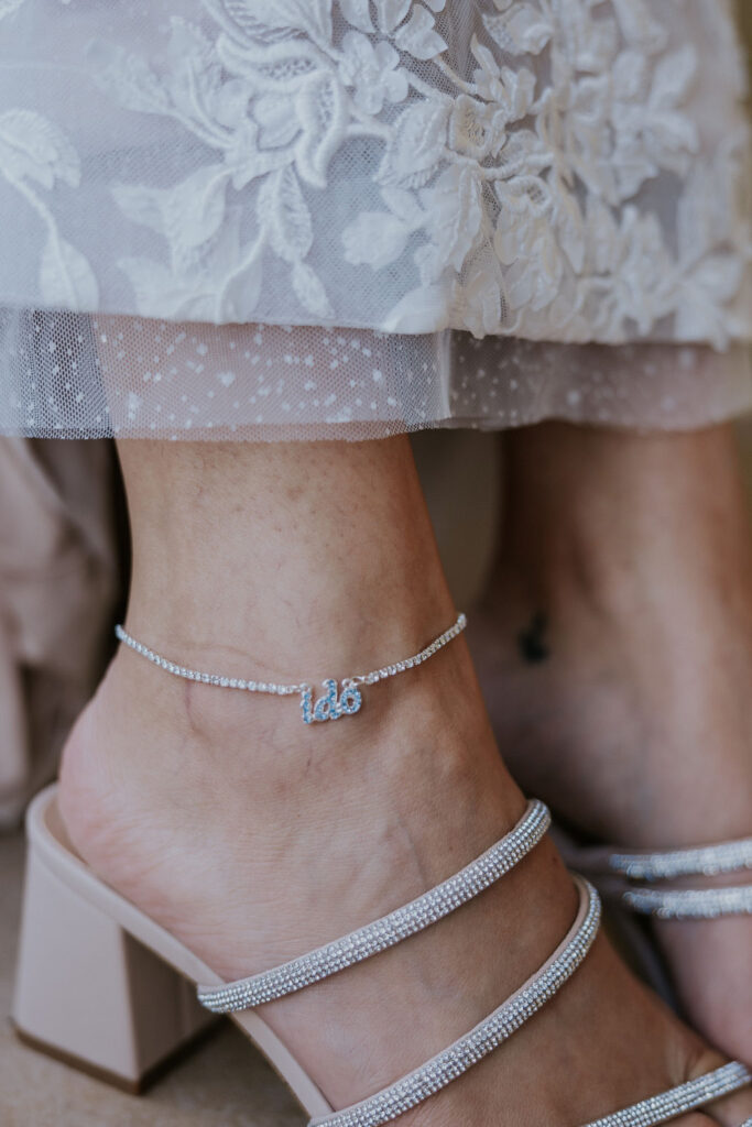 Destination wedding photographer captures bride wearing something blue anklet with 'i do' on it