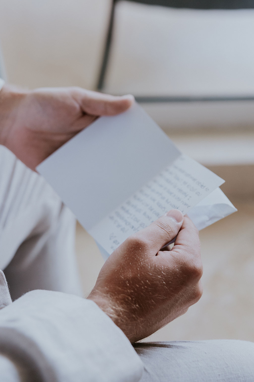 Destination wedding photographer captures groom reading letter from bride