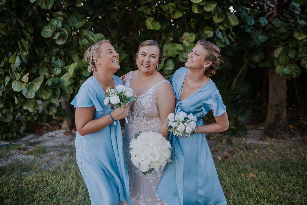 Destination wedding photographer captures bride laughing and celebrating with bridesmaids